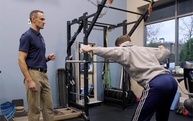 Sports Physician working with an athlete during a sport rehabilitation session at True Sport Care sport medicine clinic near Smithtown NY