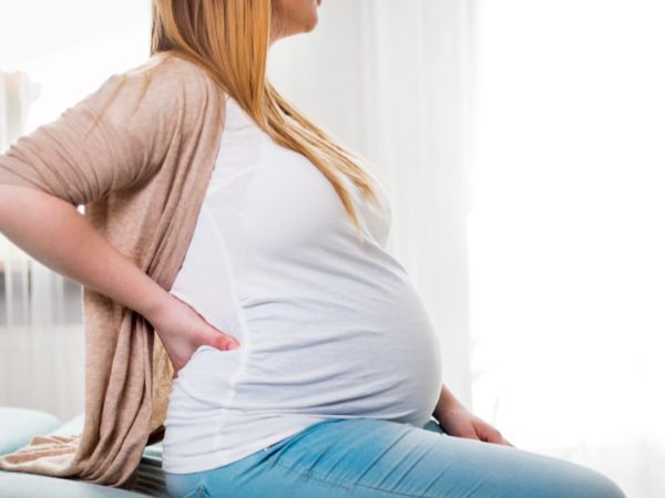 Pregnant woman experiencing sciatica pain