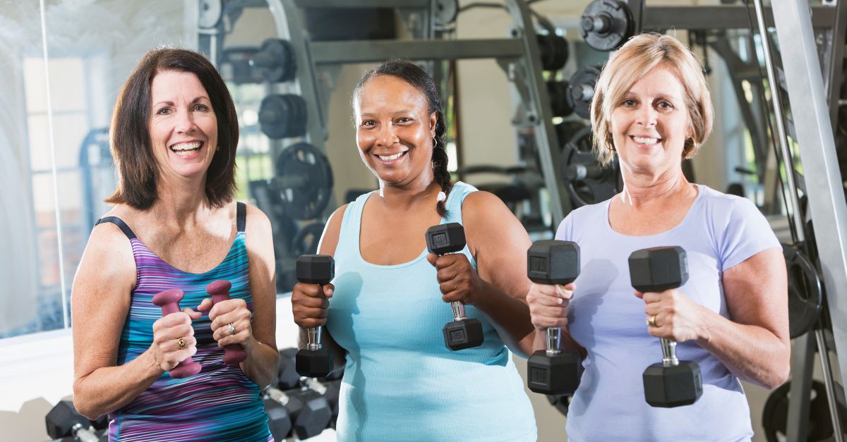Menopausal women doing weight lifting to alleviate pain and joint pain during menopause