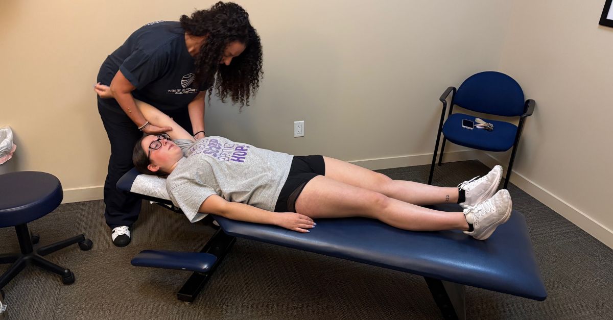 multi-disciplinary approach Dr Hope Miller chiropractor performing neck adjustment on young woman during tech neck treatment at True Sport Care and Chiropractic in Smithtown